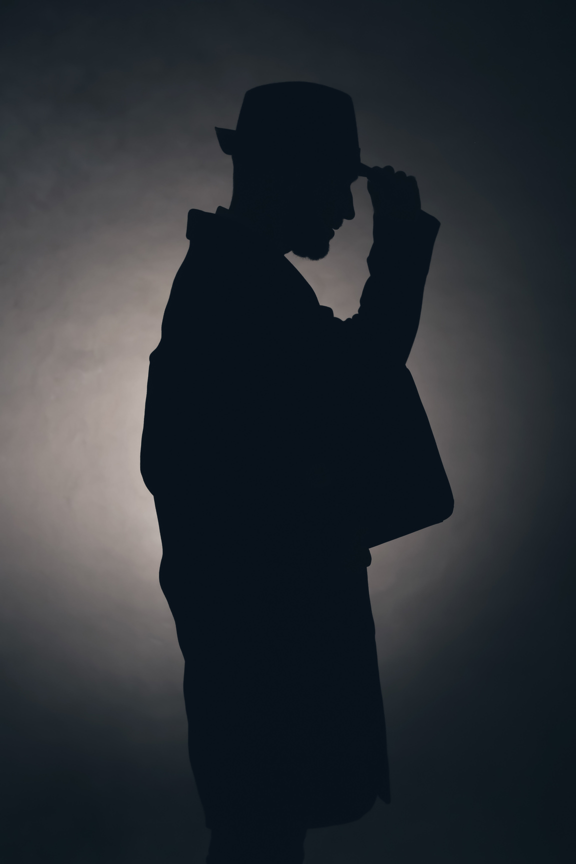 Silhouette of Detective on Dark Background
